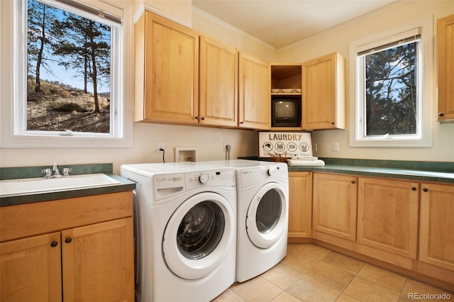 725 Sun Valley Dr, Woodland Park, CO 80863 - laundry room with cabinet space, washing machine and clothes dryer, light tile patterned flooring, and crown molding