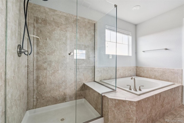 full bath featuring a shower stall and a bath