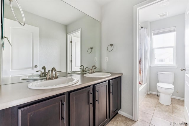 bathroom with a sink, toilet, double vanity, and visible vents