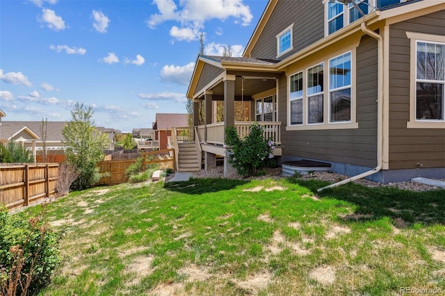 view of home's exterior featuring fence and a yard