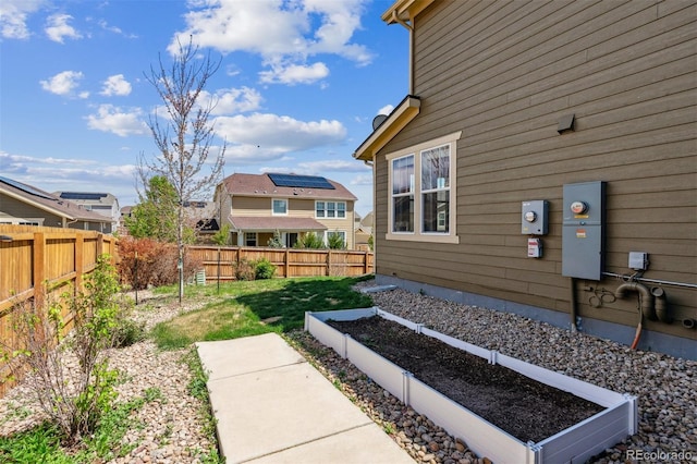view of yard featuring a fenced backyard and a vegetable garden