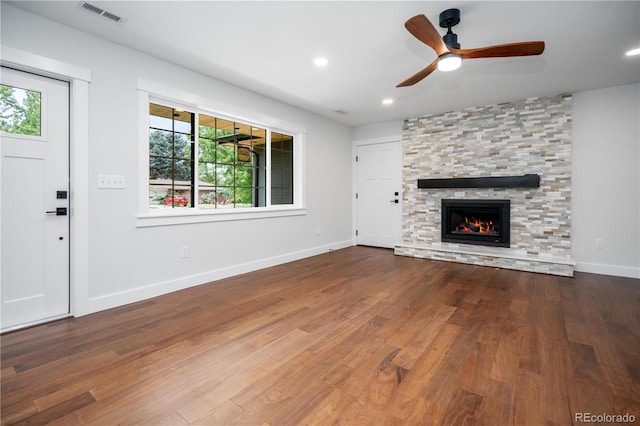404 S Oneida Way, Denver, CO 80224 - unfurnished living room featuring a stone fireplace, a ceiling fan, wood finished floors, and recessed lighting