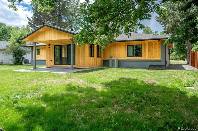 404 S Oneida Way, Denver, CO 80224 - back of property with a patio area, a lawn, and roof with shingles