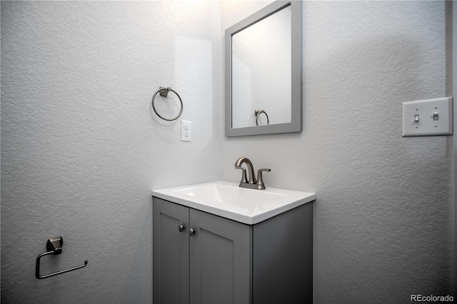 404 S Oneida Way, Denver, CO 80224 - bathroom featuring vanity and a textured wall