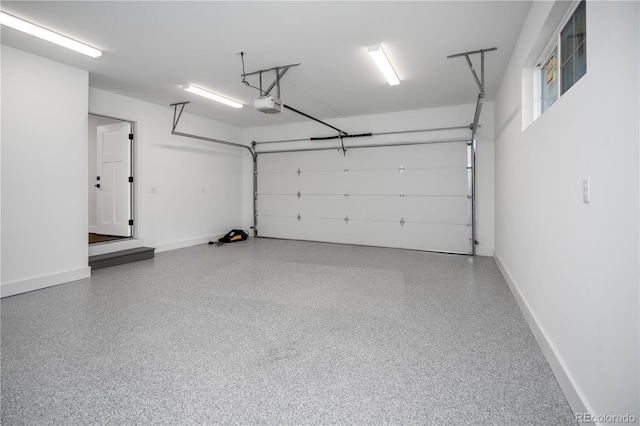 404 S Oneida Way, Denver, CO 80224 - garage with a garage door opener and baseboards