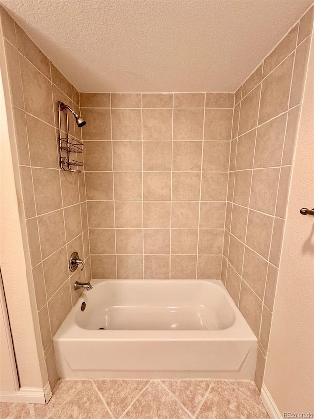 full bath with tile patterned flooring, a textured ceiling, and shower / bathing tub combination