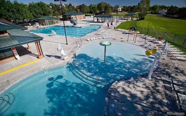 pool with a gazebo, a patio area, fence, a water play area, and a water slide