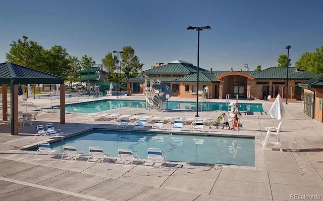 pool with a gazebo and a patio area