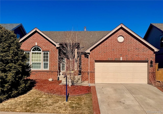 ranch-style home with a garage, concrete driveway, and brick siding