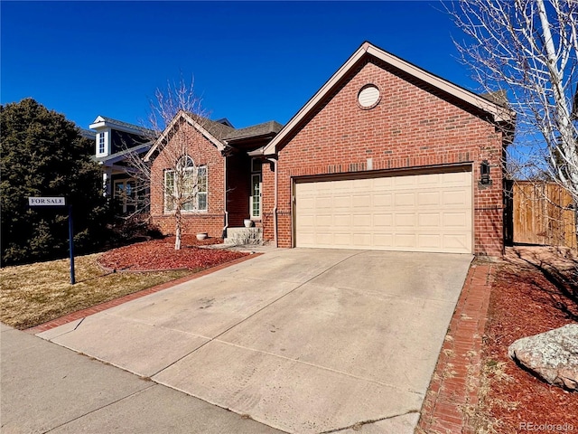 ranch-style house featuring concrete driveway, brick siding, and an attached garage