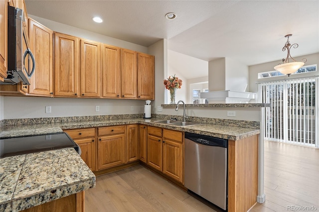 kitchen featuring pendant lighting, sink, stainless steel dishwasher, and light wood-type flooring