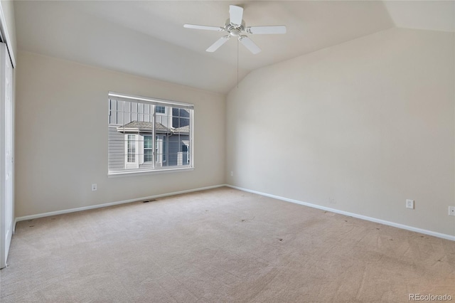 unfurnished room featuring ceiling fan, lofted ceiling, and light carpet