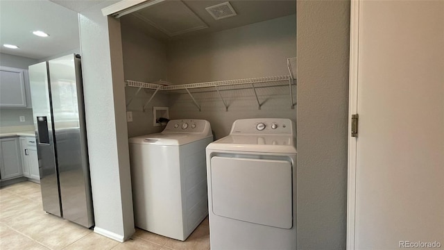 clothes washing area with visible vents, laundry area, recessed lighting, independent washer and dryer, and light tile patterned floors