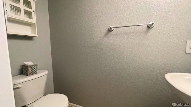 half bath featuring toilet