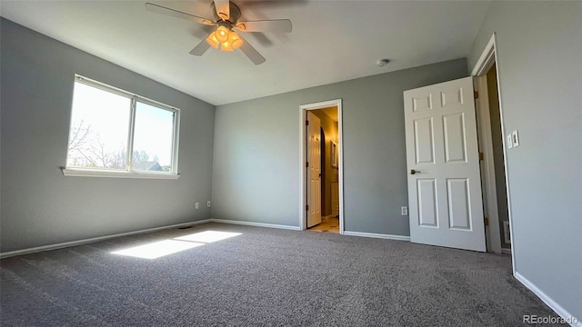 unfurnished bedroom featuring carpet floors, baseboards, and ceiling fan