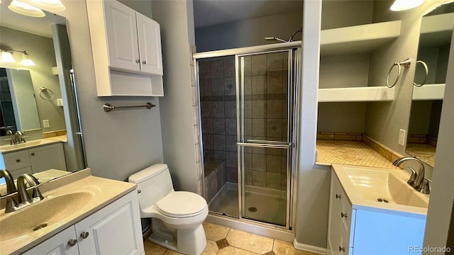 full bath featuring toilet, a shower stall, and a sink