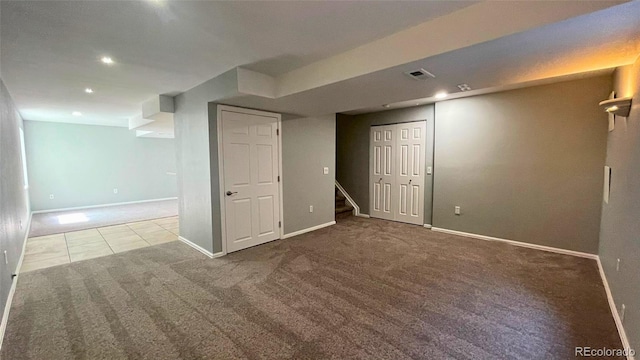 finished below grade area with baseboards, carpet flooring, recessed lighting, and stairway