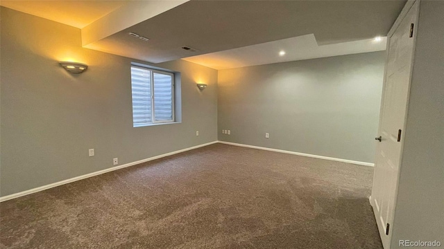 interior space with dark colored carpet, recessed lighting, baseboards, and visible vents