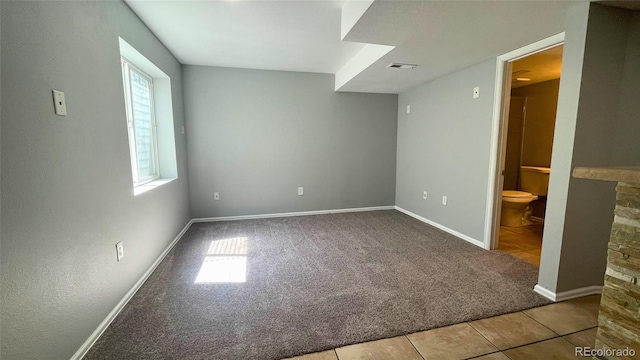 unfurnished bedroom featuring carpet floors, baseboards, and multiple windows