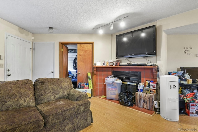 living room featuring a textured ceiling and wood finished floors