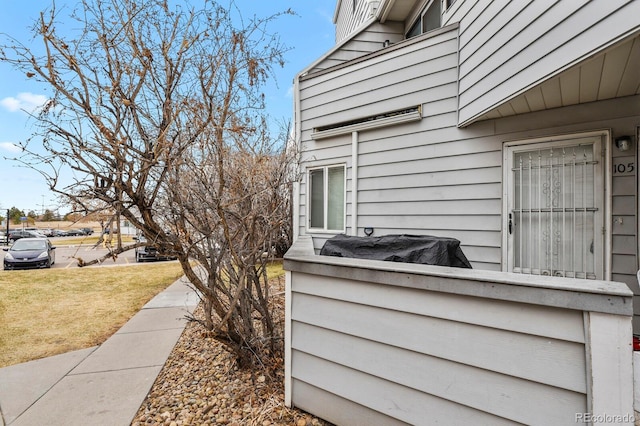 view of side of home with a yard