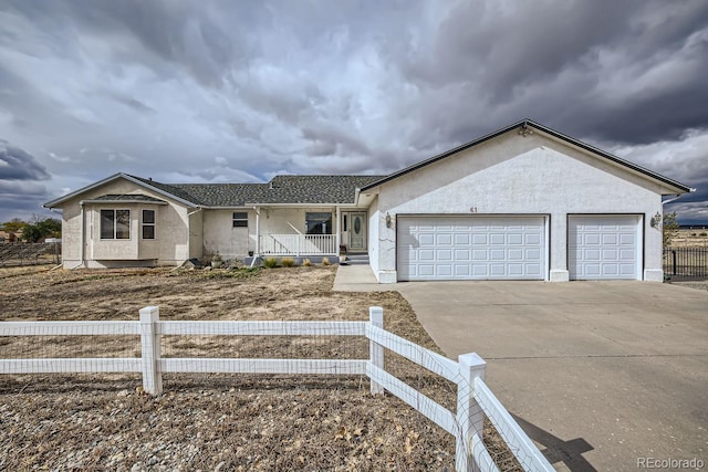 single story home featuring a porch and a garage