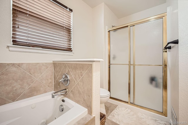 bathroom featuring toilet and independent shower and bath