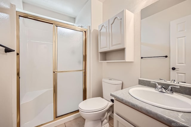 bathroom with vanity, tile patterned flooring, walk in shower, and toilet