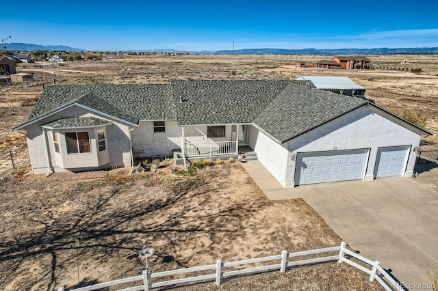 view of front of property with a porch, a garage, and a mountain view