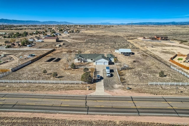 birds eye view of property featuring a mountain view