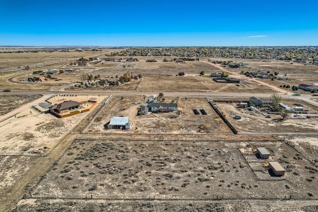 birds eye view of property with a rural view