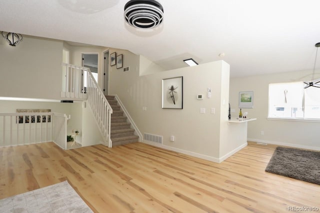 4302 Nepal St, Denver, CO 80249 - unfurnished living room featuring wood finished floors, baseboards, and stairs
