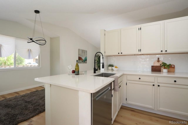 4302 Nepal St, Denver, CO 80249 - kitchen featuring stainless steel dishwasher, a peninsula, lofted ceiling, light wood-style flooring, and tasteful backsplash