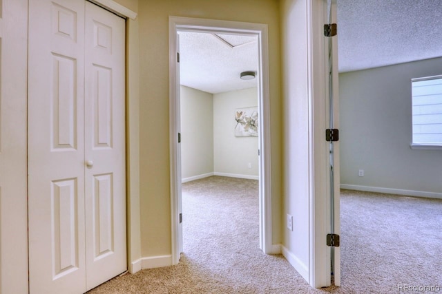 4302 Nepal St, Denver, CO 80249 - hallway featuring a textured ceiling, carpet floors, and baseboards