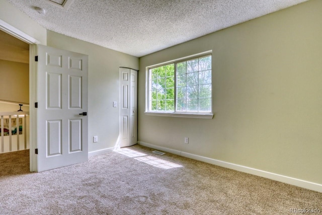 4302 Nepal St, Denver, CO 80249 - unfurnished bedroom featuring carpet, baseboards, a textured ceiling, and a closet