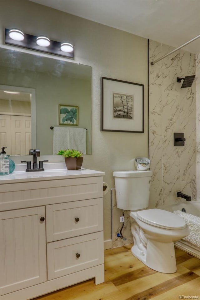 4302 Nepal St, Denver, CO 80249 - full bath with vanity, wood finished floors, toilet, and shower / bathtub combination