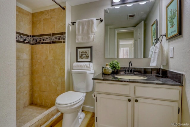 4302 Nepal St, Denver, CO 80249 - full bath with toilet, a tile shower, vanity, and wood finished floors