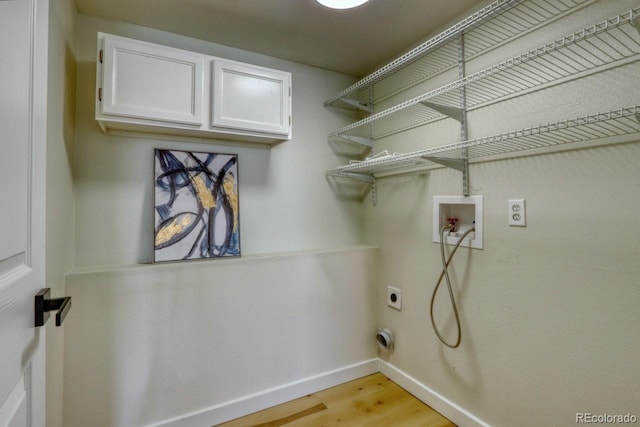 4302 Nepal St, Denver, CO 80249 - washroom featuring electric dryer hookup, light wood-style flooring, baseboards, cabinet space, and washer hookup