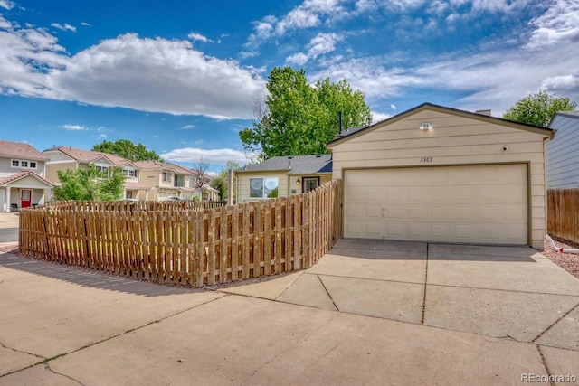 4302 Nepal St, Denver, CO 80249 - view of front of home with a garage, a residential view, and concrete driveway