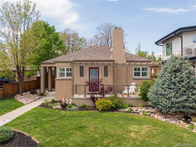 4425 Irving St, Denver, CO 80211 - view of front of home with a chimney, brick siding, and roof with shingles