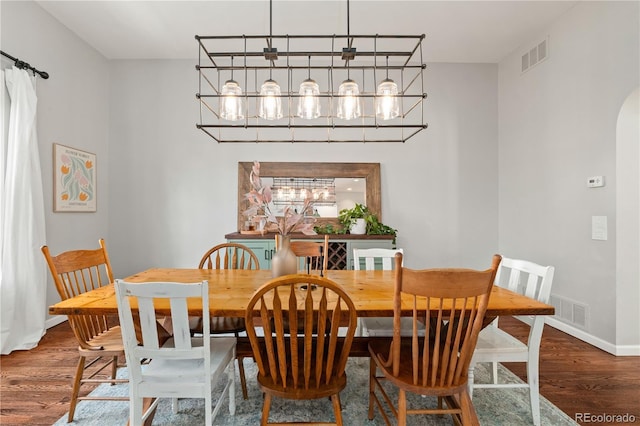 4425 Irving St, Denver, CO 80211 - dining room featuring wood finished floors, baseboards, and a chandelier