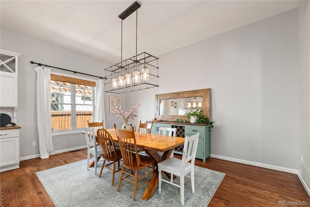 4425 Irving St, Denver, CO 80211 - dining room with a chandelier, dark wood-style floors, and baseboards