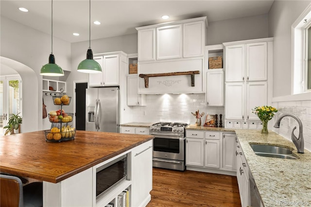 4425 Irving St, Denver, CO 80211 - kitchen with appliances with stainless steel finishes, a sink, butcher block counters, white cabinetry, and recessed lighting