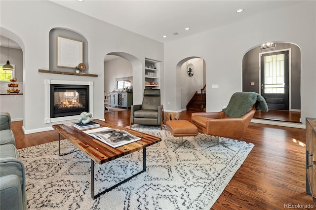 4425 Irving St, Denver, CO 80211 - living room featuring built in features, healthy amount of natural light, wood finished floors, recessed lighting, and a multi sided fireplace