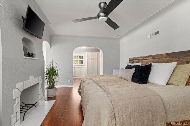 4425 Irving St, Denver, CO 80211 - bedroom featuring arched walkways, wood finished floors, baseboards, and ceiling fan