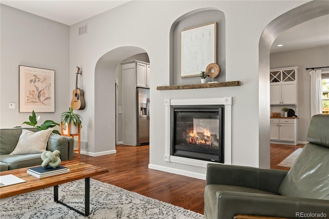 4425 Irving St, Denver, CO 80211 - living room featuring dark wood-type flooring, baseboards, and a glass covered fireplace