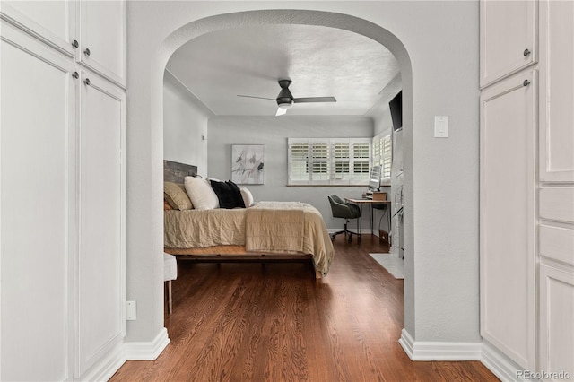 4425 Irving St, Denver, CO 80211 - bedroom featuring arched walkways, wood finished floors, baseboards, and a ceiling fan