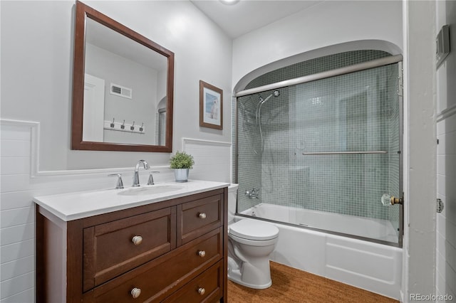4425 Irving St, Denver, CO 80211 - bathroom featuring toilet, vanity, shower / bath combination with glass door, and tile walls