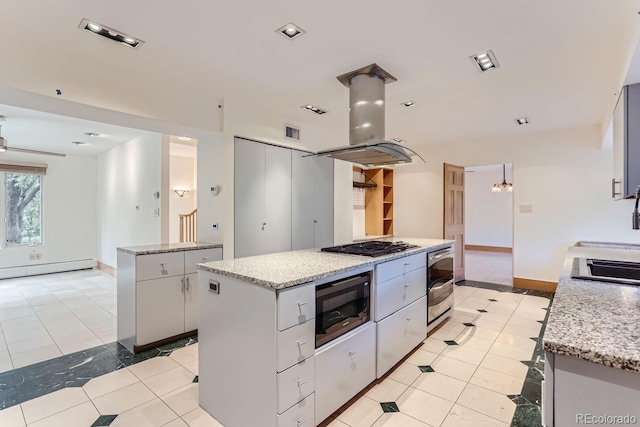 kitchen with light tile patterned floors, built in microwave, island exhaust hood, and a center island