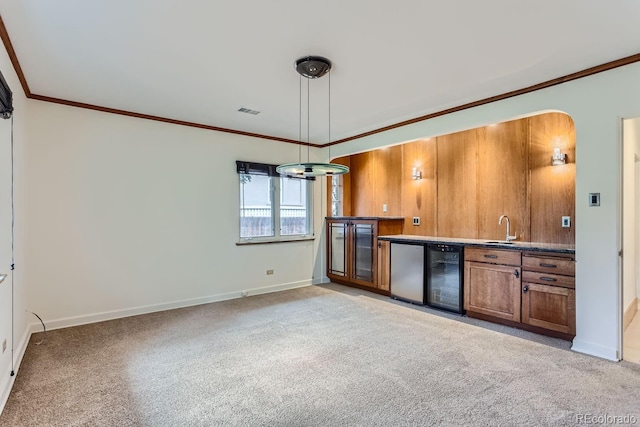 kitchen featuring beverage cooler, decorative light fixtures, light carpet, sink, and fridge